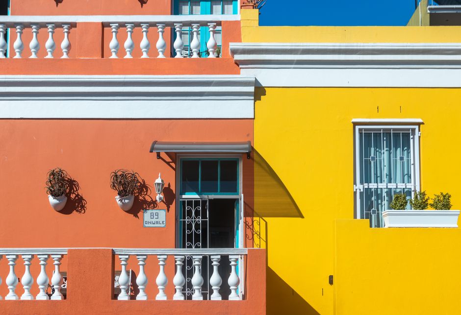 Painted house walls in bright orange and yellow.